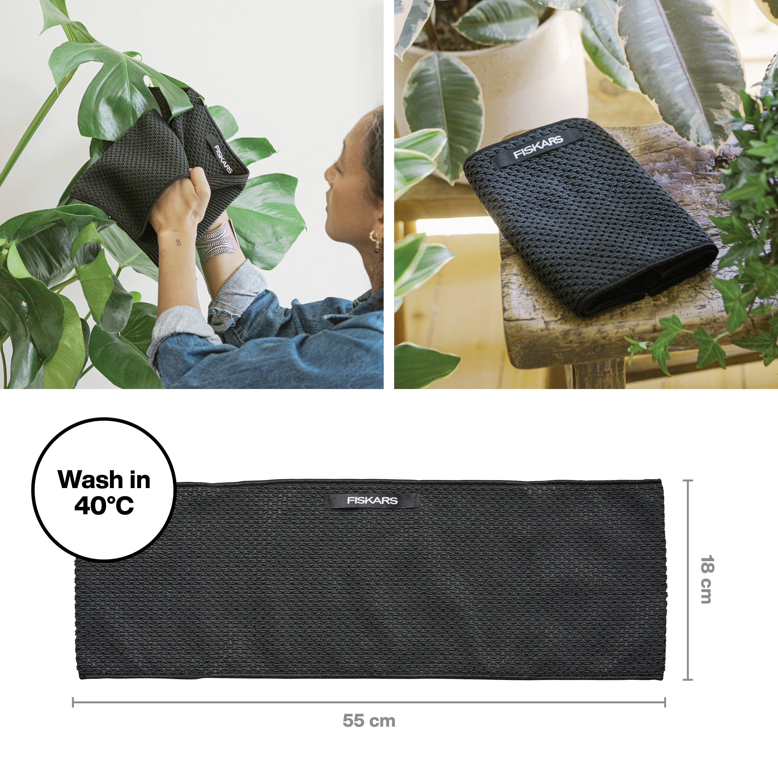 Osoba čisti list biljke crnom krpom tvrtke Fiskars; uz nju je krpa postavljena na stolu. Dimenzije: 55 x 18 cm. Može se prati na 40°C.