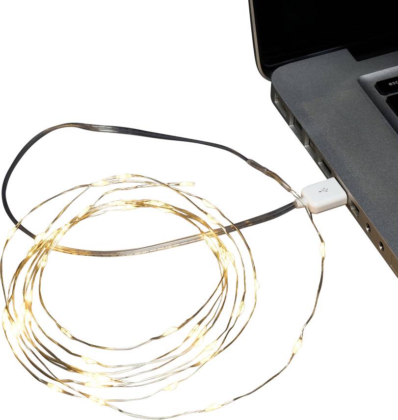 Savijeni niz malih LED žarulja povezan USB-om s prijenosnim računalom, blago svijetleći pored tipkovnice prijenosnog računala.