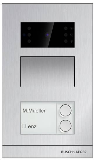 Zvončić s kamerom, slots za oznake i gumbima. Imena na oznakama: 'M.Mueller' i 'I.Lenz'. Branding: 'Busch-Jaeger'.