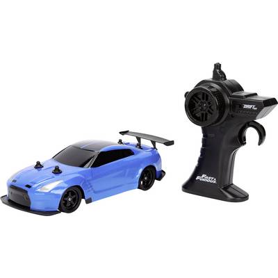 Plavi automobil na daljinsko upravljanje pored crnog kontrolera, s logotipom 'Fast & Furious' brenda.