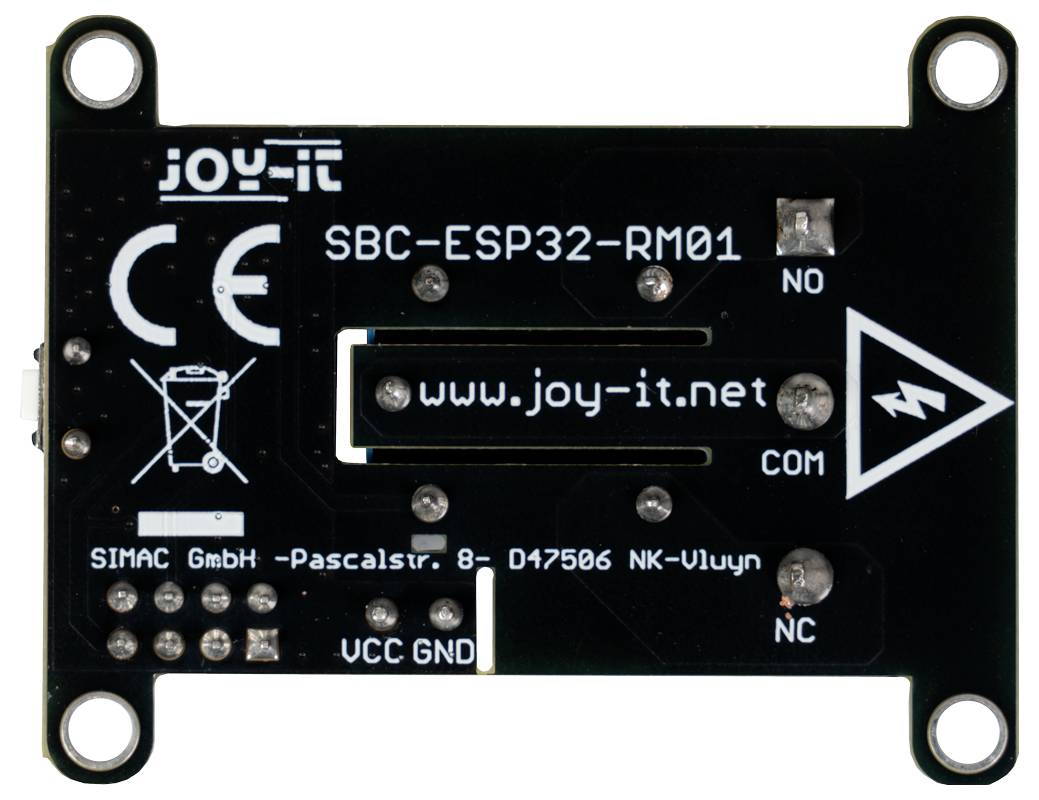 Slika prikazuje stražnju stranu ploče razvojnog sustava Joy-It SBC-ESP32-RM01 s različitim natpisima uključujući 'www.joy-it.net' i oznake priključaka.
