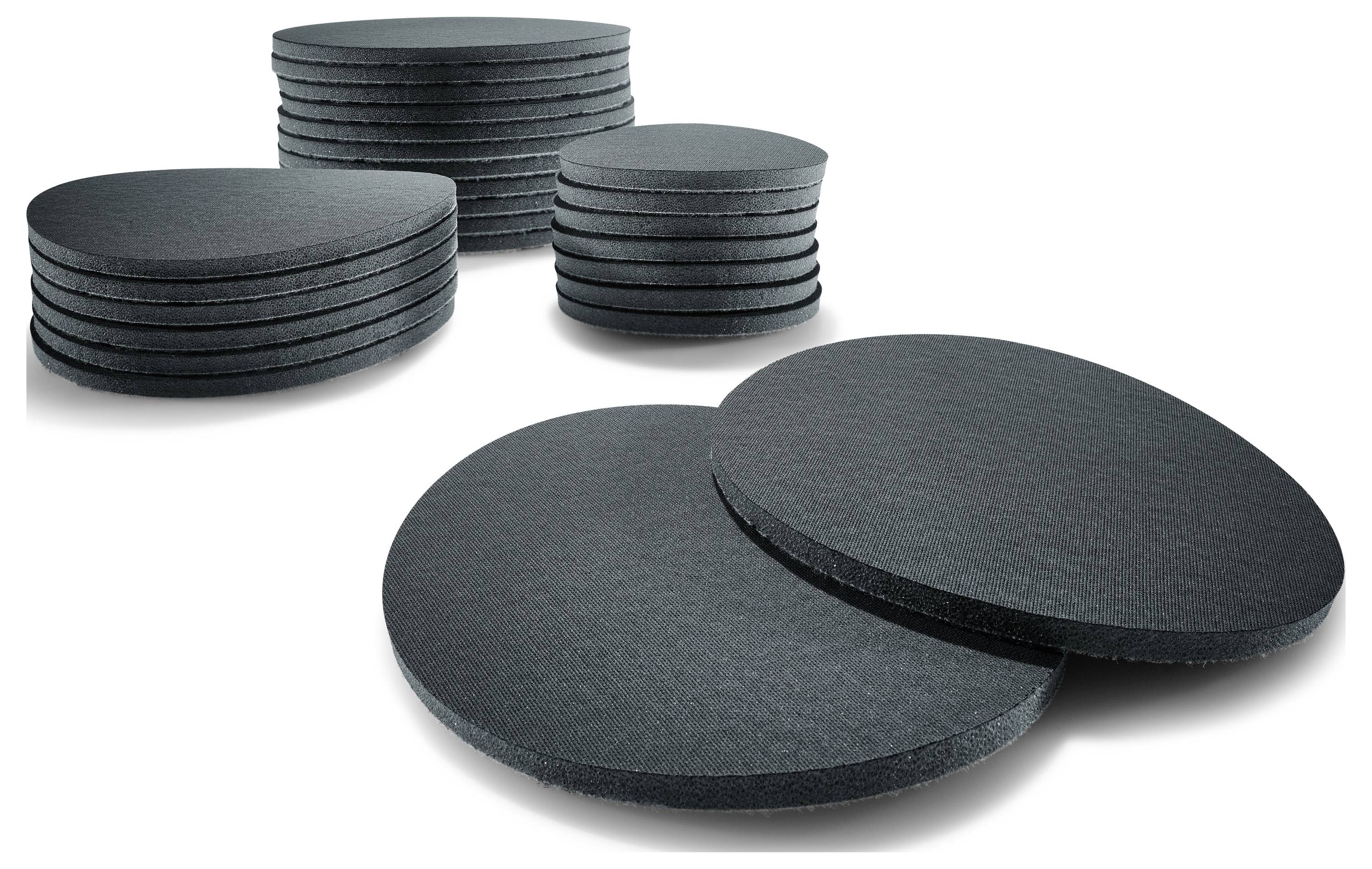 Nekoliko hrpa crnih kružnih pjenastih podloga različitih veličina raspoređenih na običnoj pozadini.