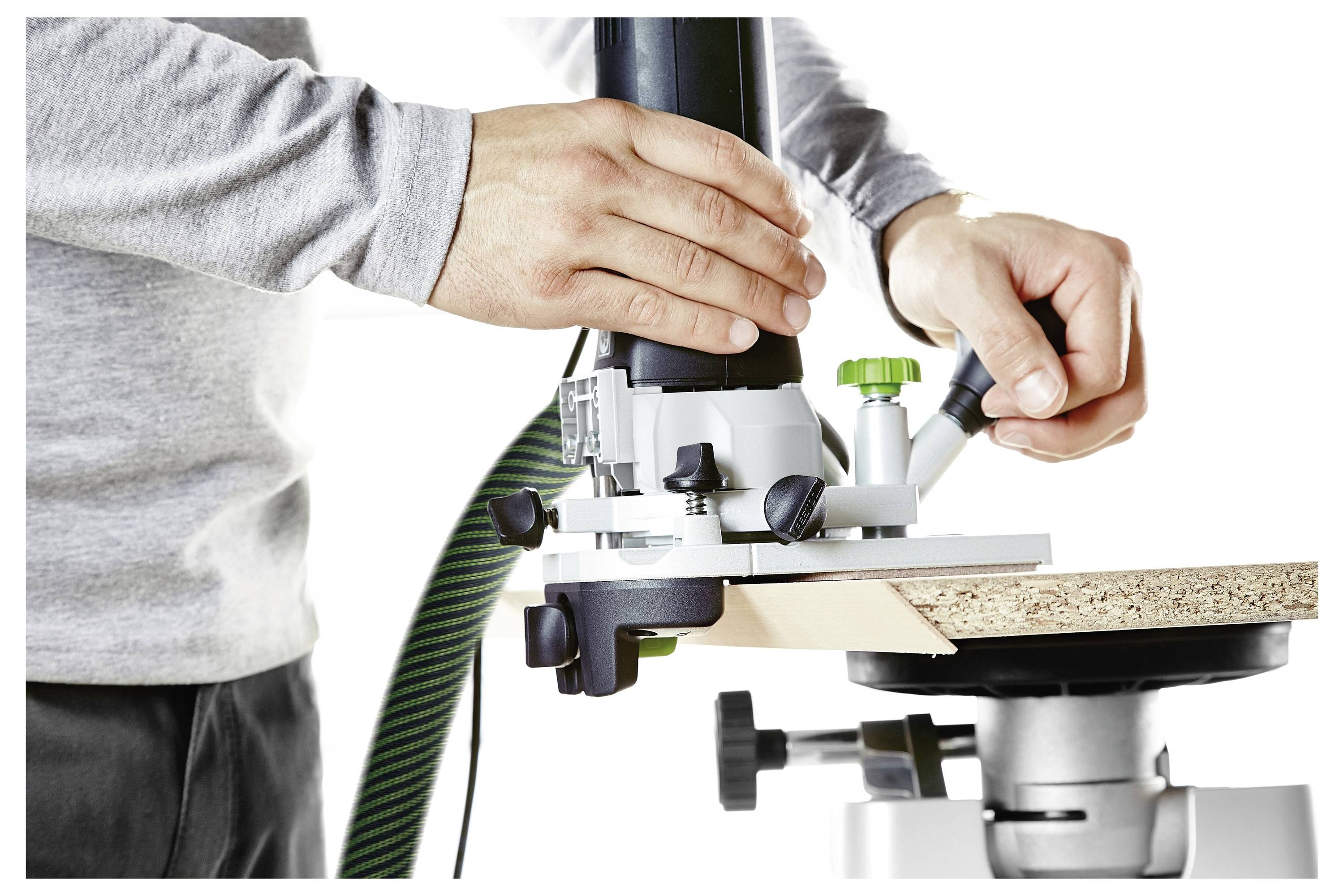 Osoba upravlja alatom za obradu drva, precizno rezanjem komada drva.