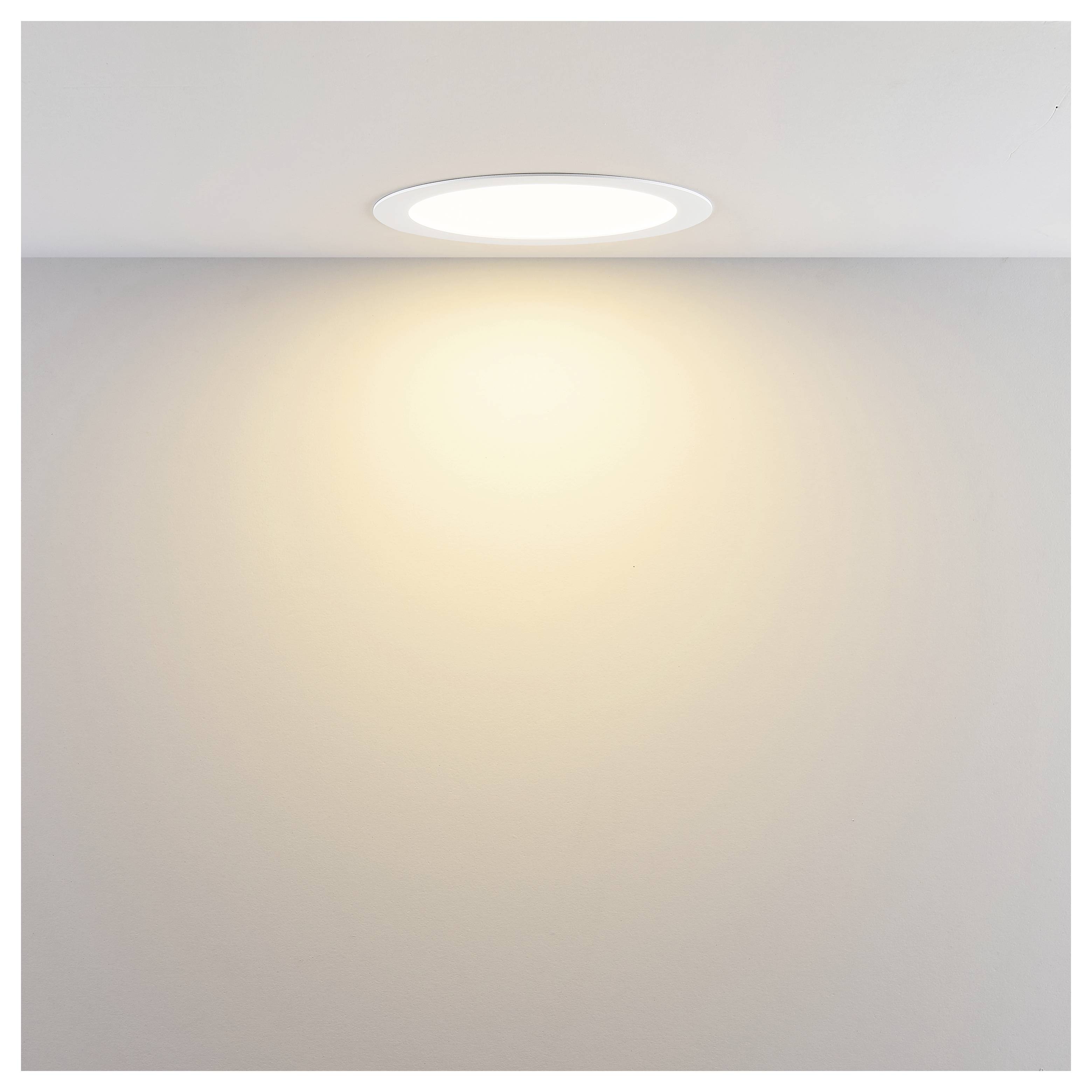 Moderna cilindrična zidna lampa koja baca svjetlo gore i dolje na bež zid.