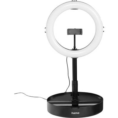 Bijela prstenasta lampa na crnoj stojaciji i podnožju, s držačem za telefon centriranim unutar prstena i vidljivim elektricknim kabelom.