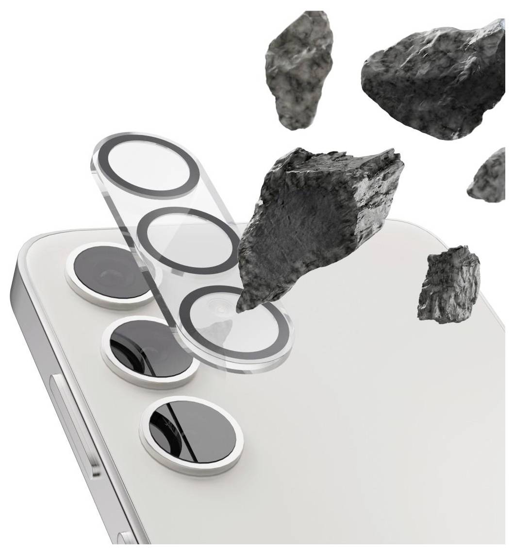 Pametni telefon s podignutim zaštitnim poklopcem leće i plutajućim kamenjem, što ilustrira zaštitu od udarca za stražnje kamere.