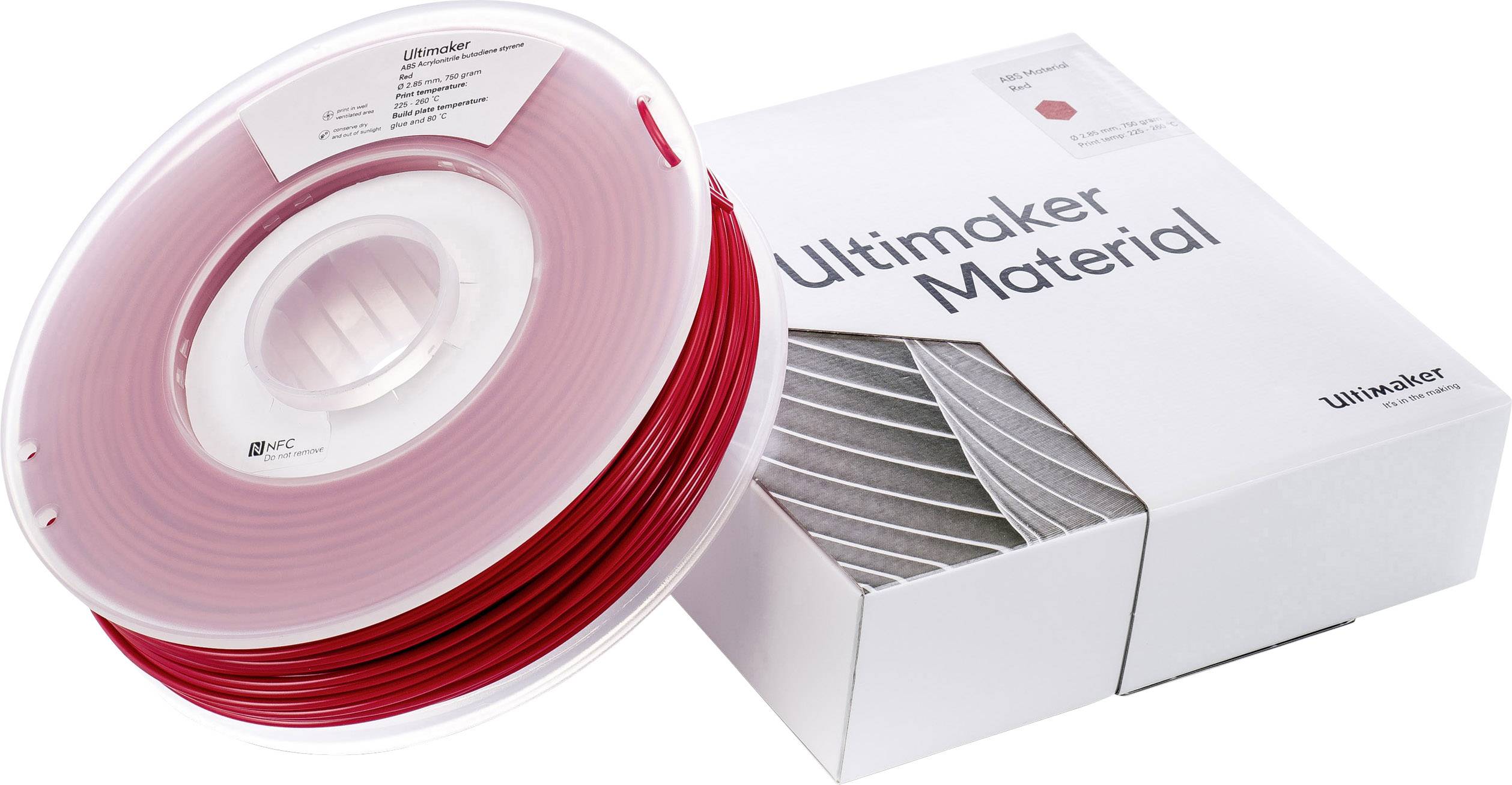 Crveni kolut 3D-pisača postavljene pored Ultimaker pakiranja materijala.