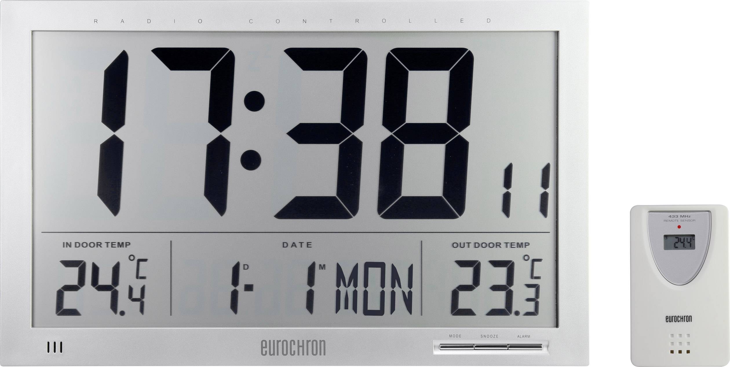Digitalni zidni sat s velikim zaslonom pokazuje 17:38, datum 1.11., i temperature: unutarnja 24,4 °C, vanjska 23,3 °C. Uključuje vanjski senzor.