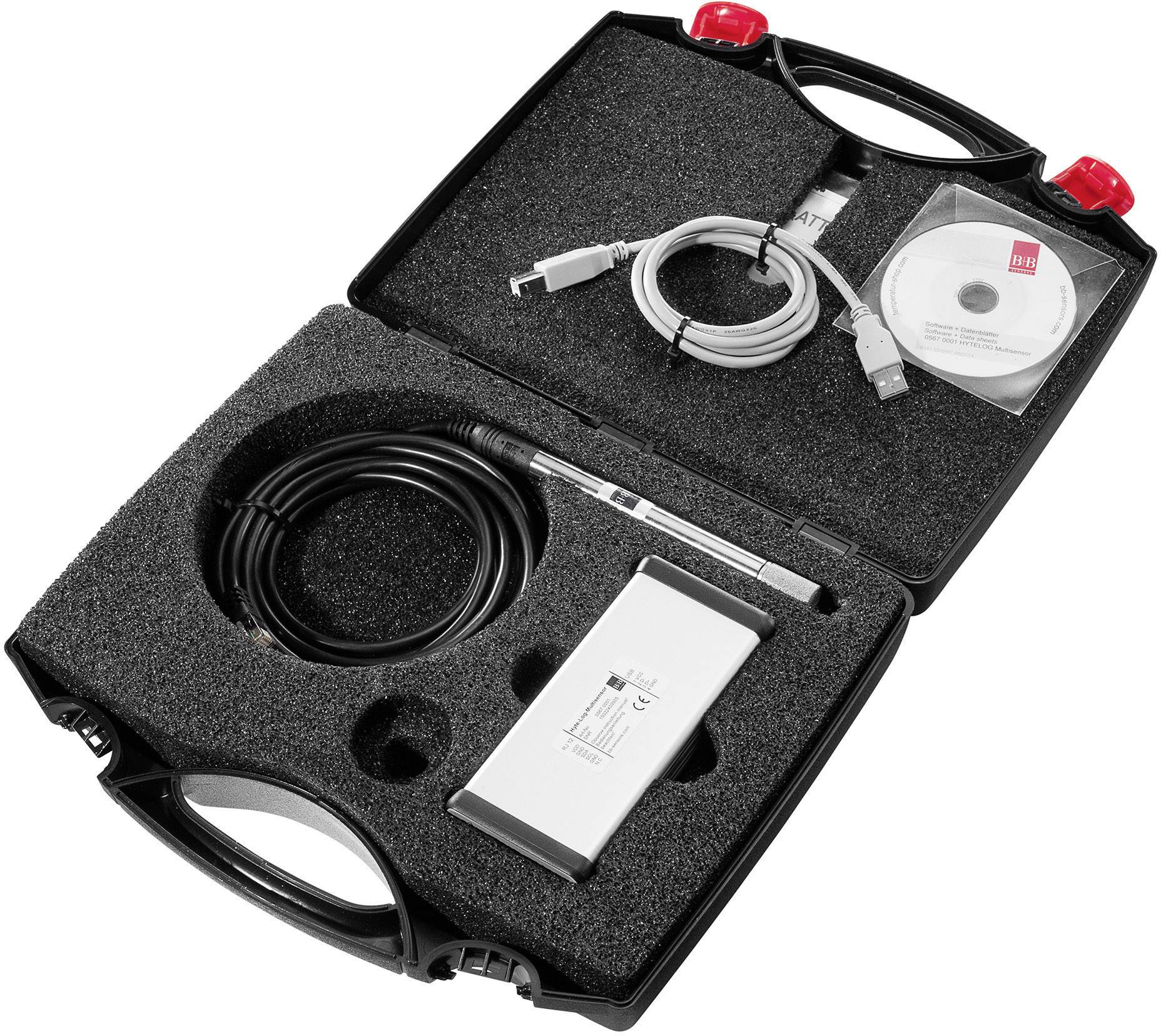 Otvoreni crni kofer s tehničkim uređajima, uključujući kablove, elektroničku jedinicu i CD.