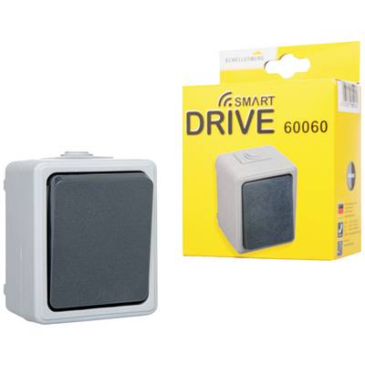 Szürke fali kapcsoló fekete gombbal egy sárga csomagolás mellett, amelyen a 'Smart DRIVE 60060' felirat és a kapcsoló képe látható.
