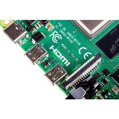 Egy egylapkás számítógép zöld áramköri kártyájának közeli felvétele, HDMI- és USB-csatlakozókkal, számos elektronikai alkatrésszel és kameranyílással.