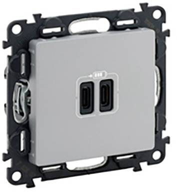 Egy négyzet alakú kapcsolóelem, amely két USB-C töltőaljzattal rendelkezik középen, fali szereléshez való tartókeretbe szerelve.