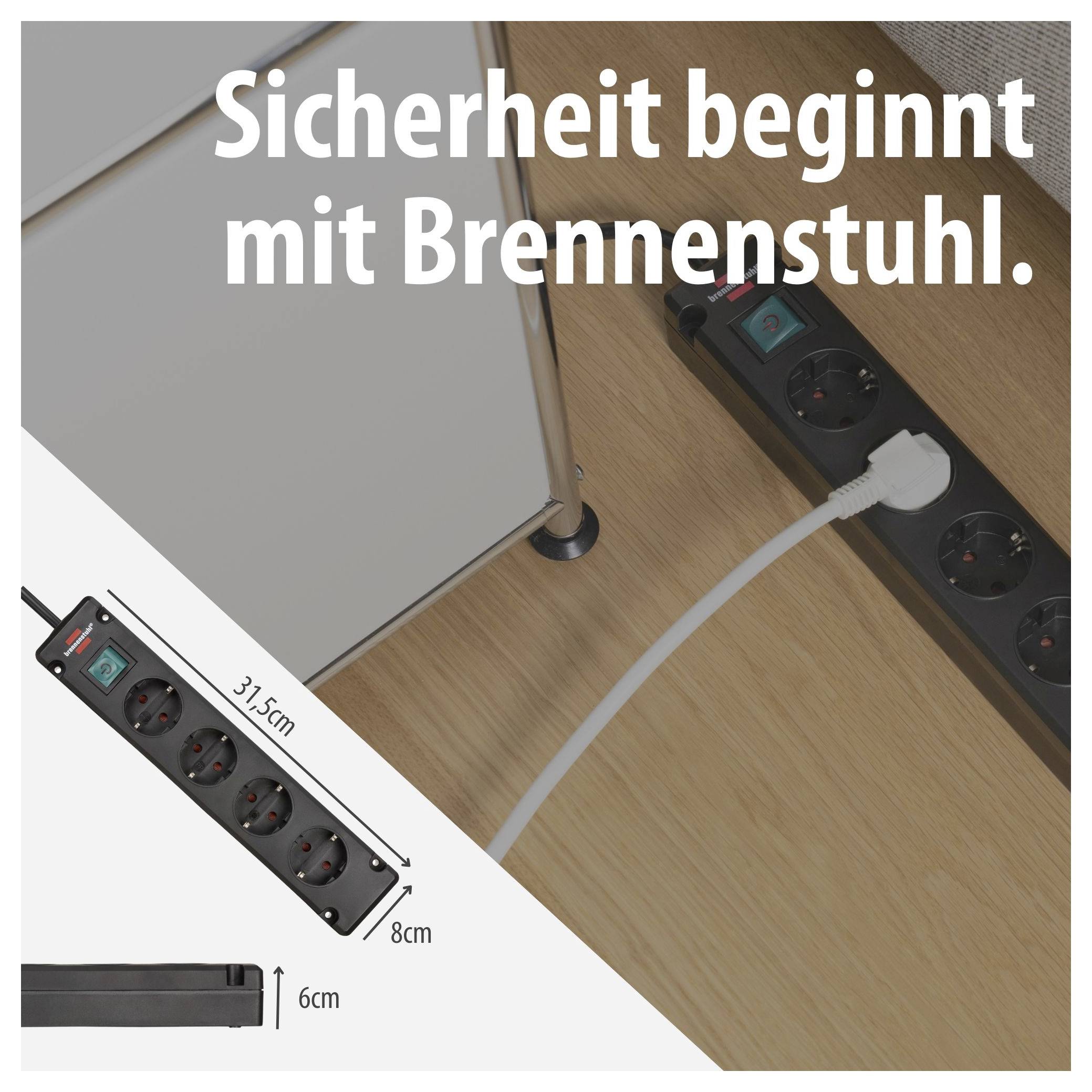 Brennenstuhl-Steckdosenleiste reklámja: fekete szalag az íróasztalon kábellel, szöveg „A biztonság a Brennenstuhlal kezdődik.", Méretek 31,5 cm, 8 cm, 6 cm.
