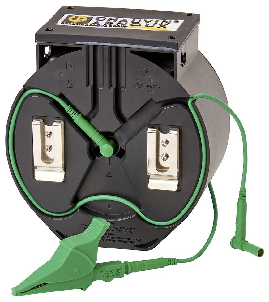 Egy kerek, fekete eszköz két fémkapoccsal és zöld kábelekkel. Valószínűleg egy elektromos mérőműszer.