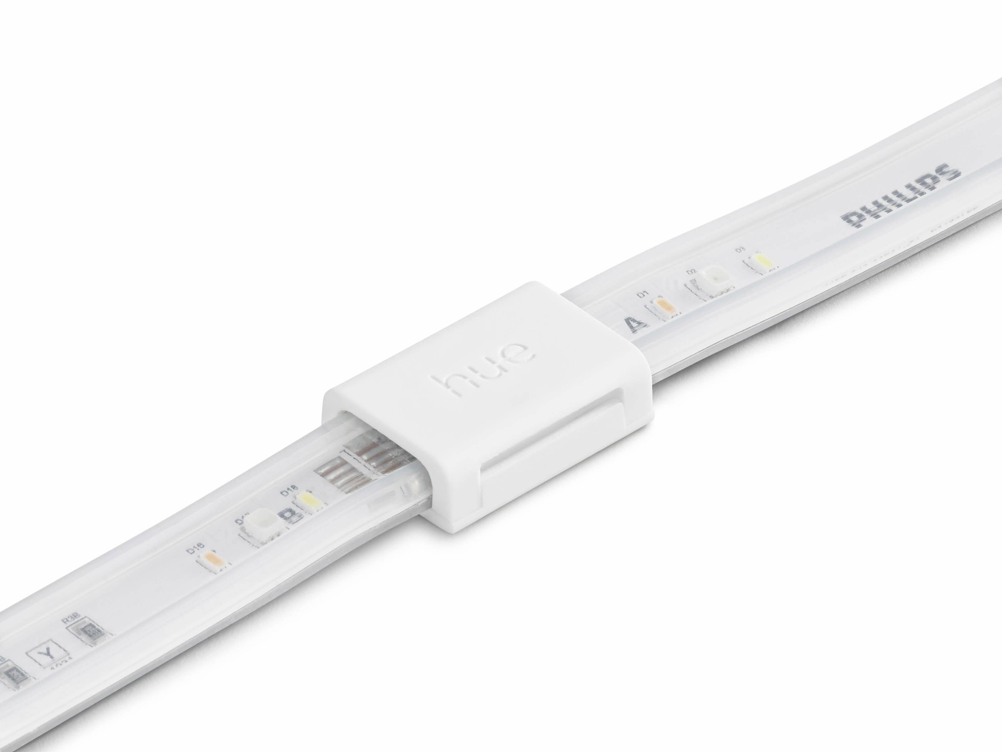 Közeli felvétel egy Philips LED-szalagról, amelyen a „hue" logó egy fehér csíptető részen látható, bemutatva a különböző LED-eket és színárnyalatokat.