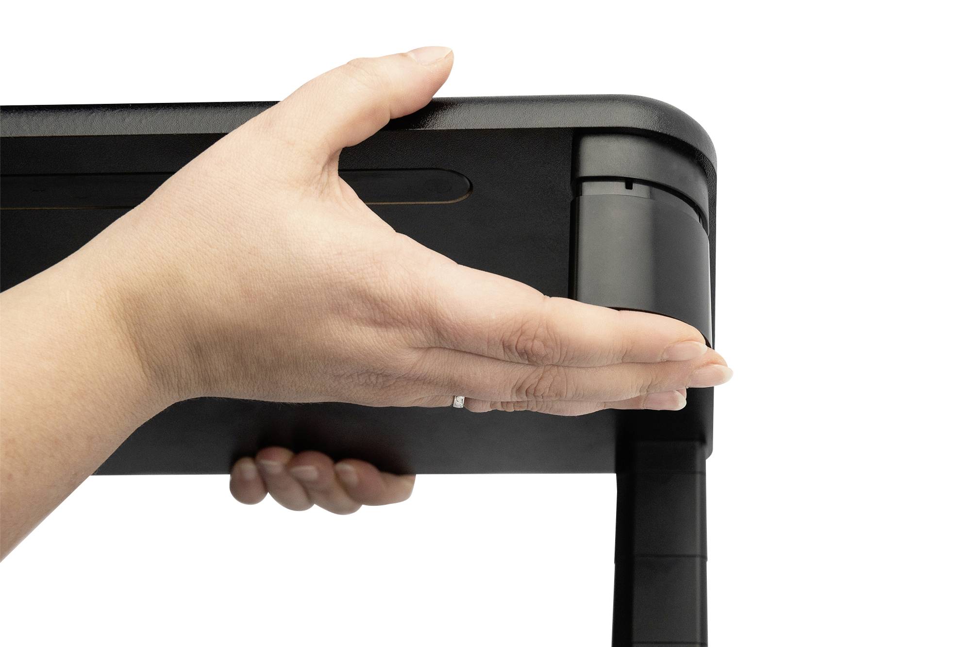 Egy kéz fogja egy asztal sarkát, valószínűleg az asztal stabilitását vagy összecsukhatóságát mutatva.