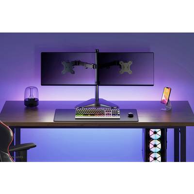 Egy íróasztal RGB-billentyűzettel, egérrel, két monitortartóval monitorok nélkül, okostelefon-tartóval és megvilágított ventilátorokkal, lágy fények által körülvéve.