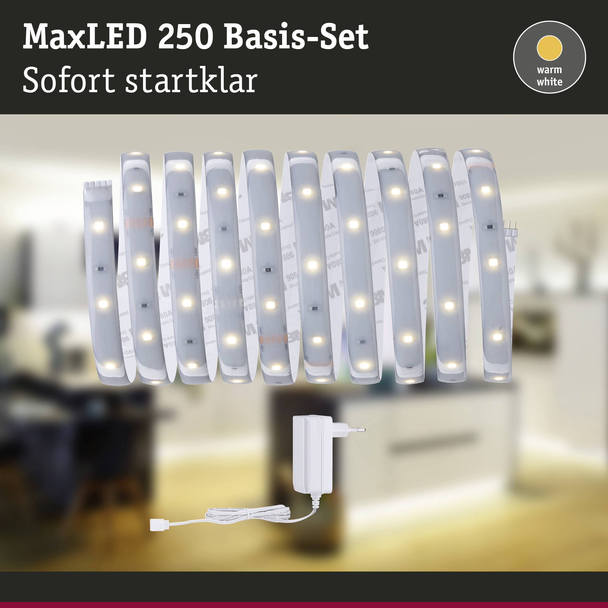 'MaxLED 250 Alapkészlet' LED-szalagot mutat tápegységgel. Szöveg: 'Azonnal használatra kész', 'meleg fehér'. A háttér elmosódott.