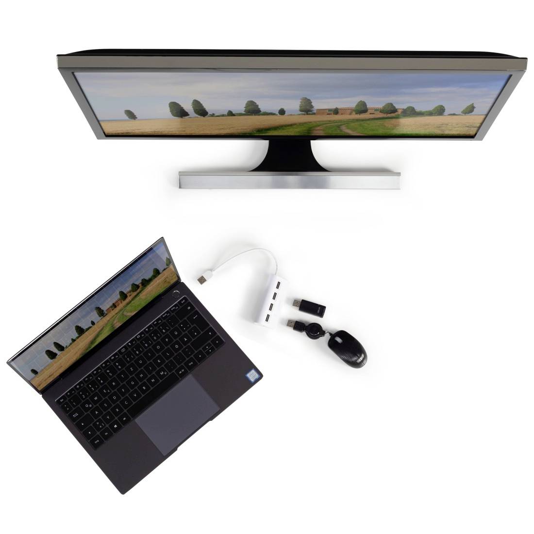 Egy nyitott laptop egy nagy monitor mellett, USB-elosztón keresztül csatlakoztatva. Mindkét képernyőn egy fákkal teli tájkép látható.