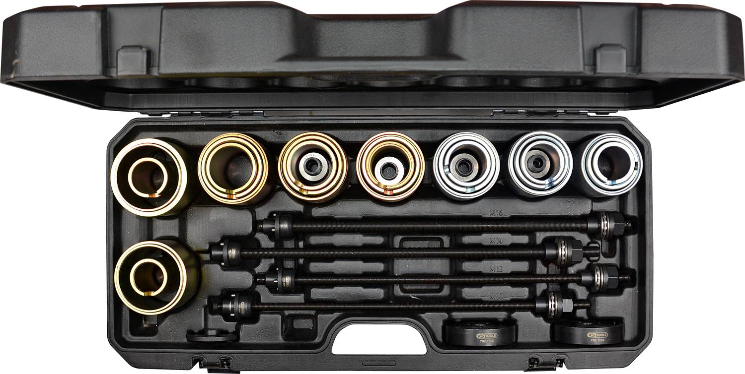 Egy szerszámoskészlet különböző kerek fémfeltétekkel és négy fekete rúddal. A koffer nyitva van, és minden alkatrész látható.