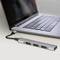 Egy laptop egy USB-C-elosztóhoz csatlakozik, amely három USB-portot biztosít. Az elosztó bővíti a laptop csatlakozási lehetőségeit.