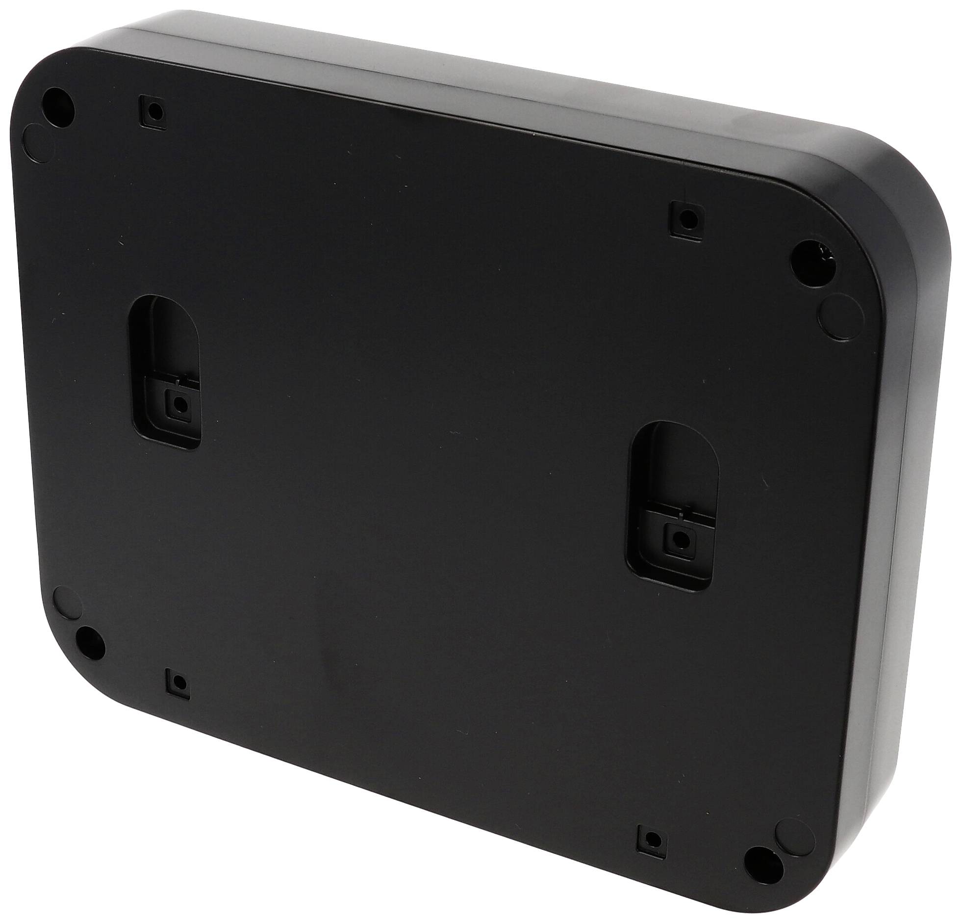 Fekete téglalap alakú ház, hátulnézet, lekerekített sarkokkal és négy kerek csavarlyukkal a sarkokon.