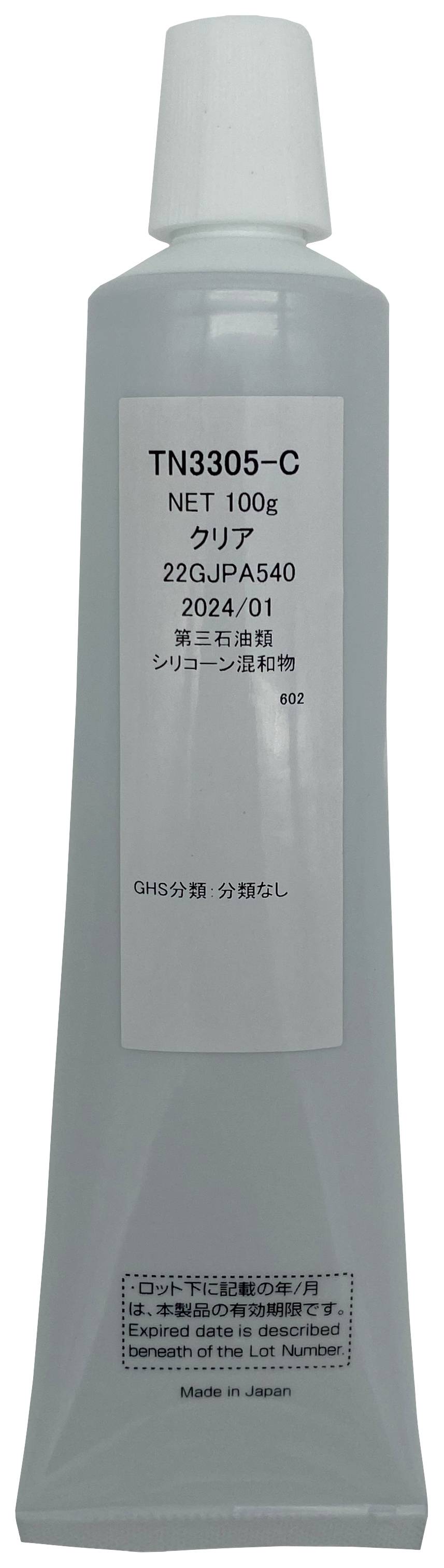 Egy szürke tubus japán írásjegyekkel ellátott címkével. Műszaki információkat tartalmaz, és alján a 'Made in Japan' felirat olvasható.