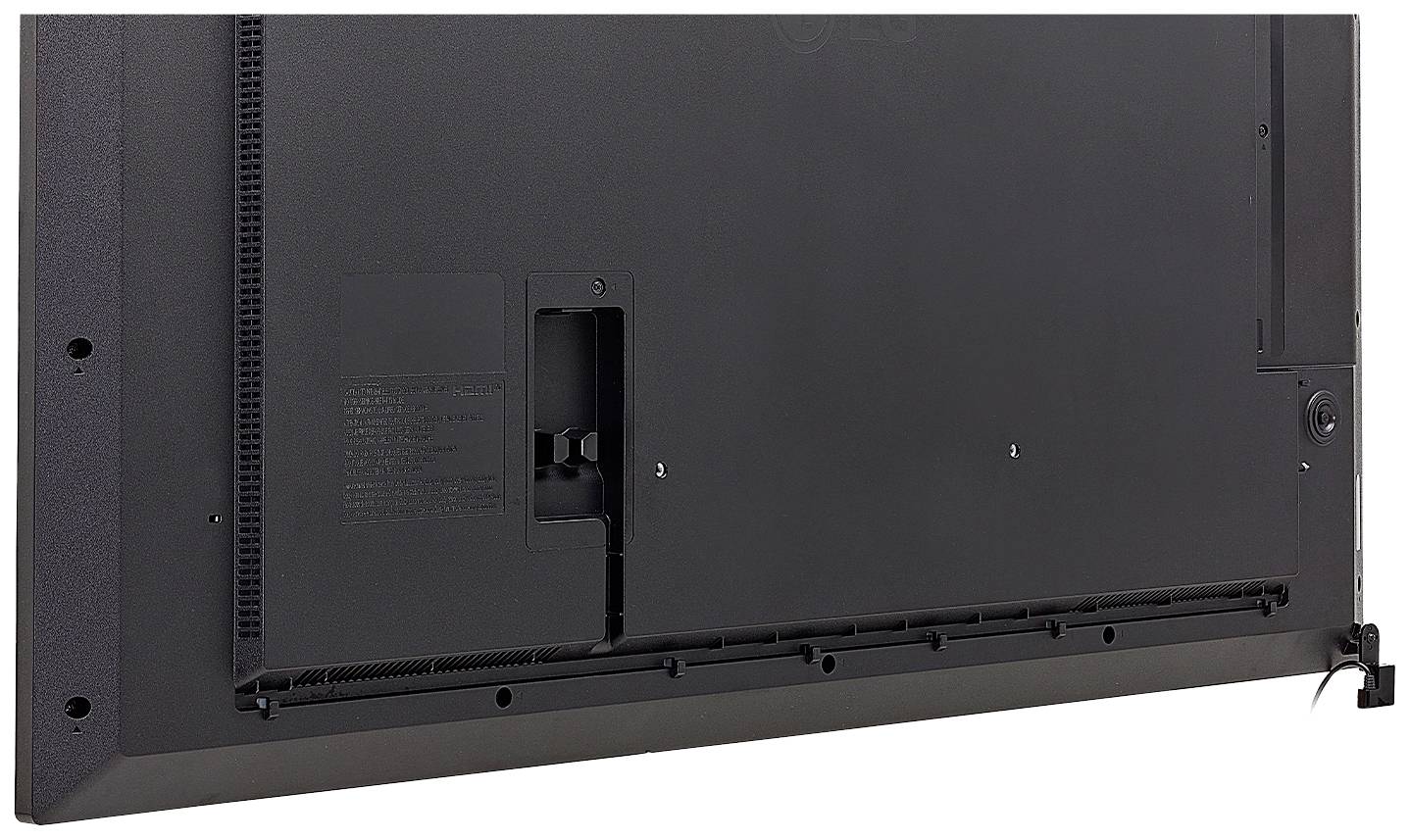 Egy fekete televízió hátoldala, amelyen több csavarlyuk és csatlakozó látható.