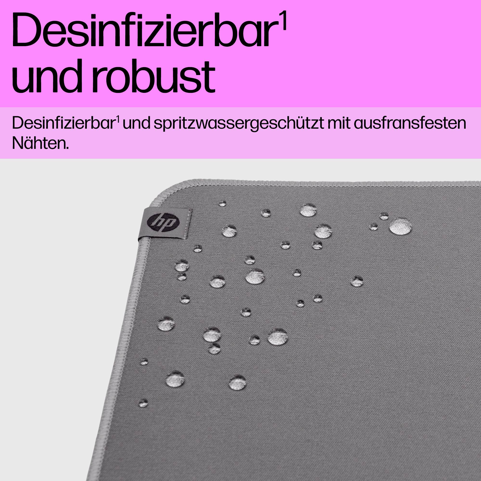 Egy szürke szőnyeg vízlepergető tulajdonságokkal, néhány vízcseppel rajta. Szöveg felül: 'Fertőtleníthető és tartós'.