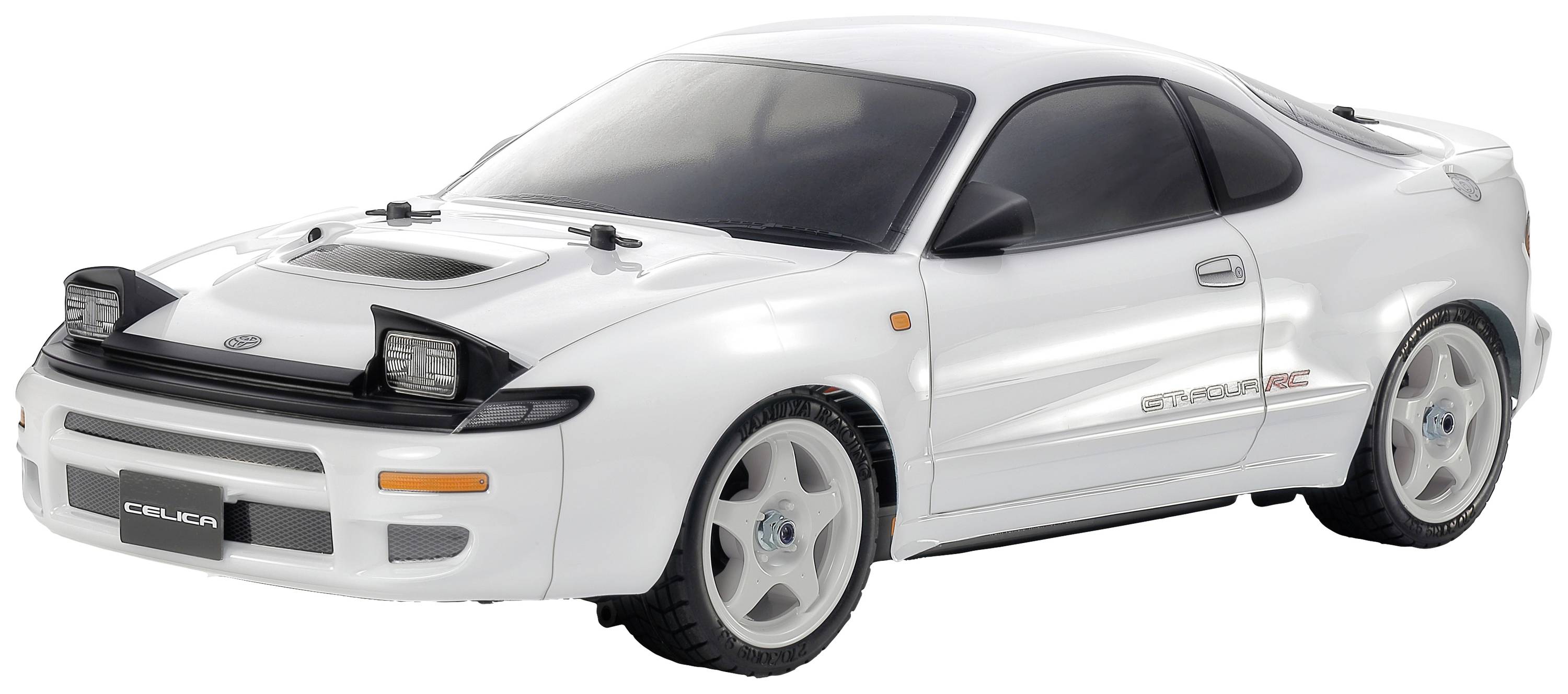 Egy fehér modellautó sportos dizájnnal és karakteres fényszórókkal, amelyen 'Celica' felirat szerepel, egy felületen áll.