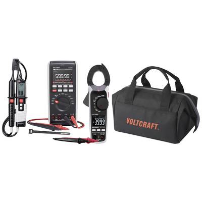 Különböző elektronikai mérőeszközök, többek között multiméter, feszültségmérő és áramfogó, egy fekete hordtáska mellett, amelyen a 'Voltcraft' felirat olvasható.