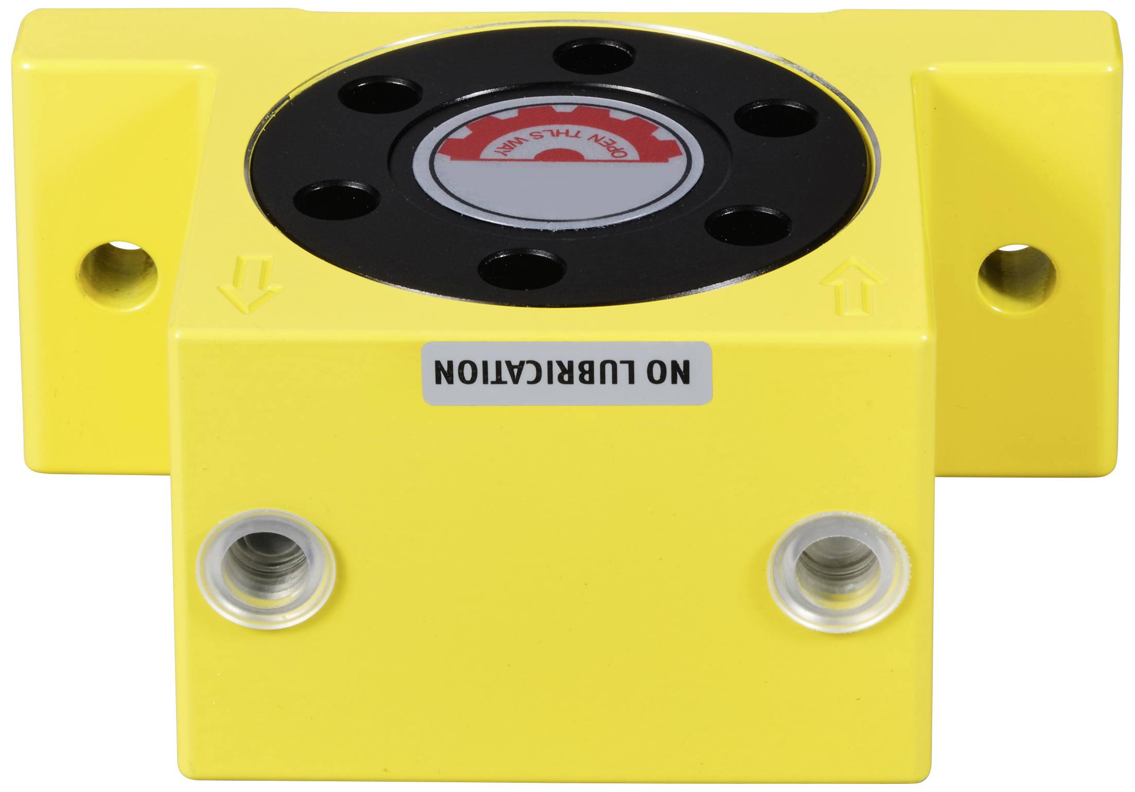 Sárga gépalkatrész fekete kerek felső résszel, amelynek tetején a 'NO LUBRICATION' felirat olvasható. Két szerelőfurat az elülső oldalon.
