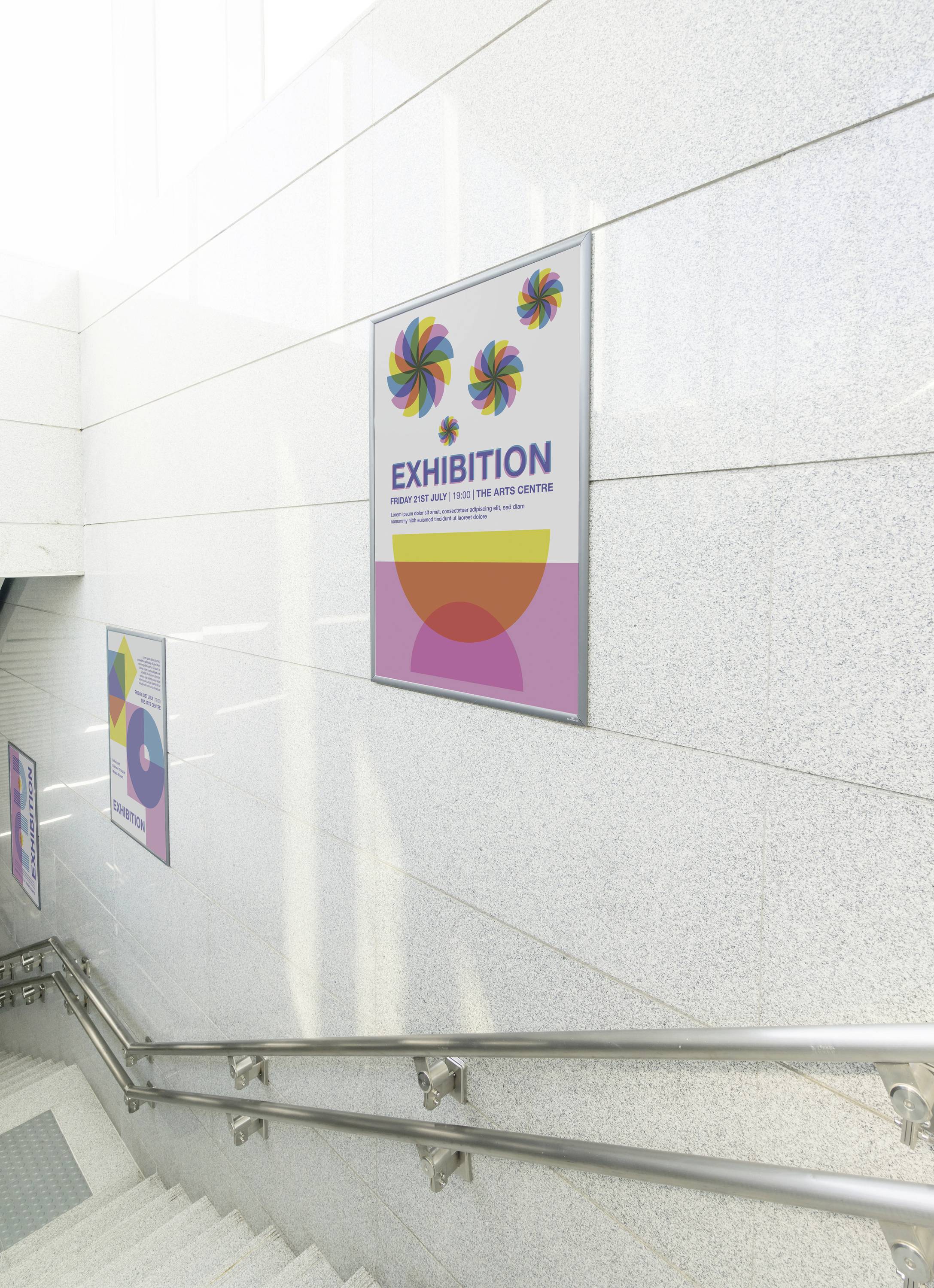 Egy plakát lóg a lépcsőházban, amely egy kiállítást hirdet a művészeti központban. A plakáton színes szélkerék képek láthatók és a 'KIÁLLÍTÁS' felirat.