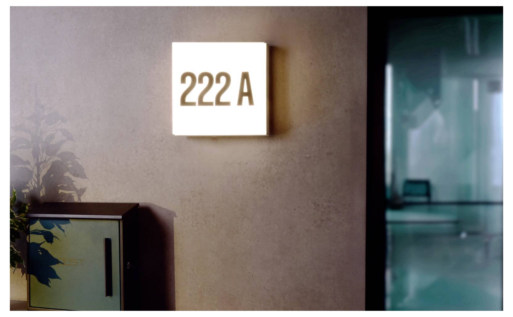 Megvilágított falitábla „222 A” felirattal egy ajtó vagy folyosó mellett, amely szobát vagy irodát jelölő számra utal.