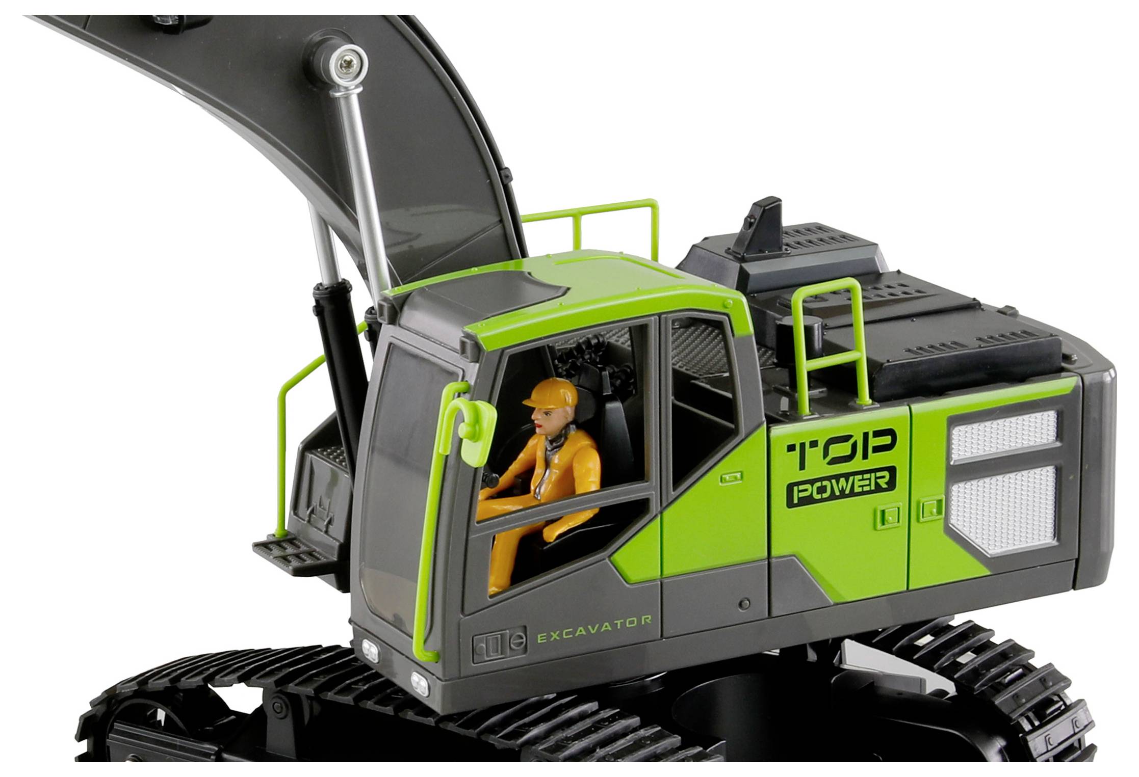 Zöld házú és fekete futóműves játék kotrógép. Egy narancssárga játékfigura ül a vezetőfülkében.