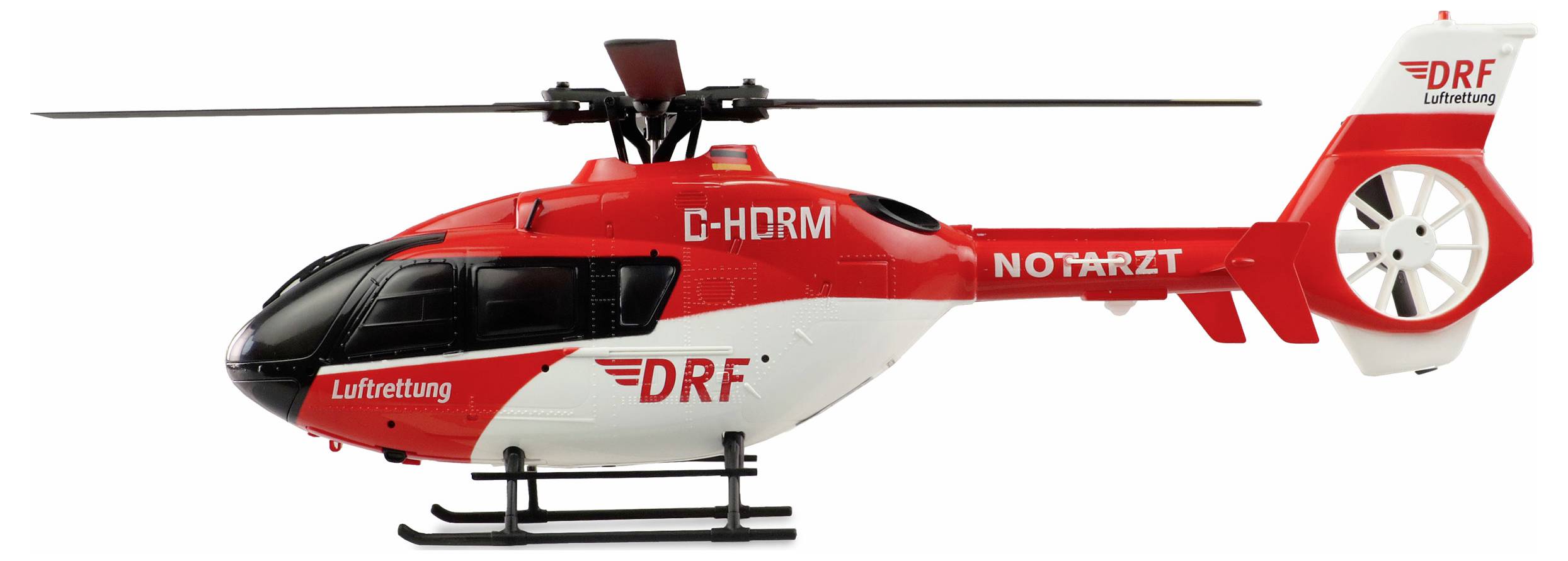 Piros és fehér mentőhelikopter 'DRF Légimentés' és 'MENTŐORVOS' felirattal az oldalán.