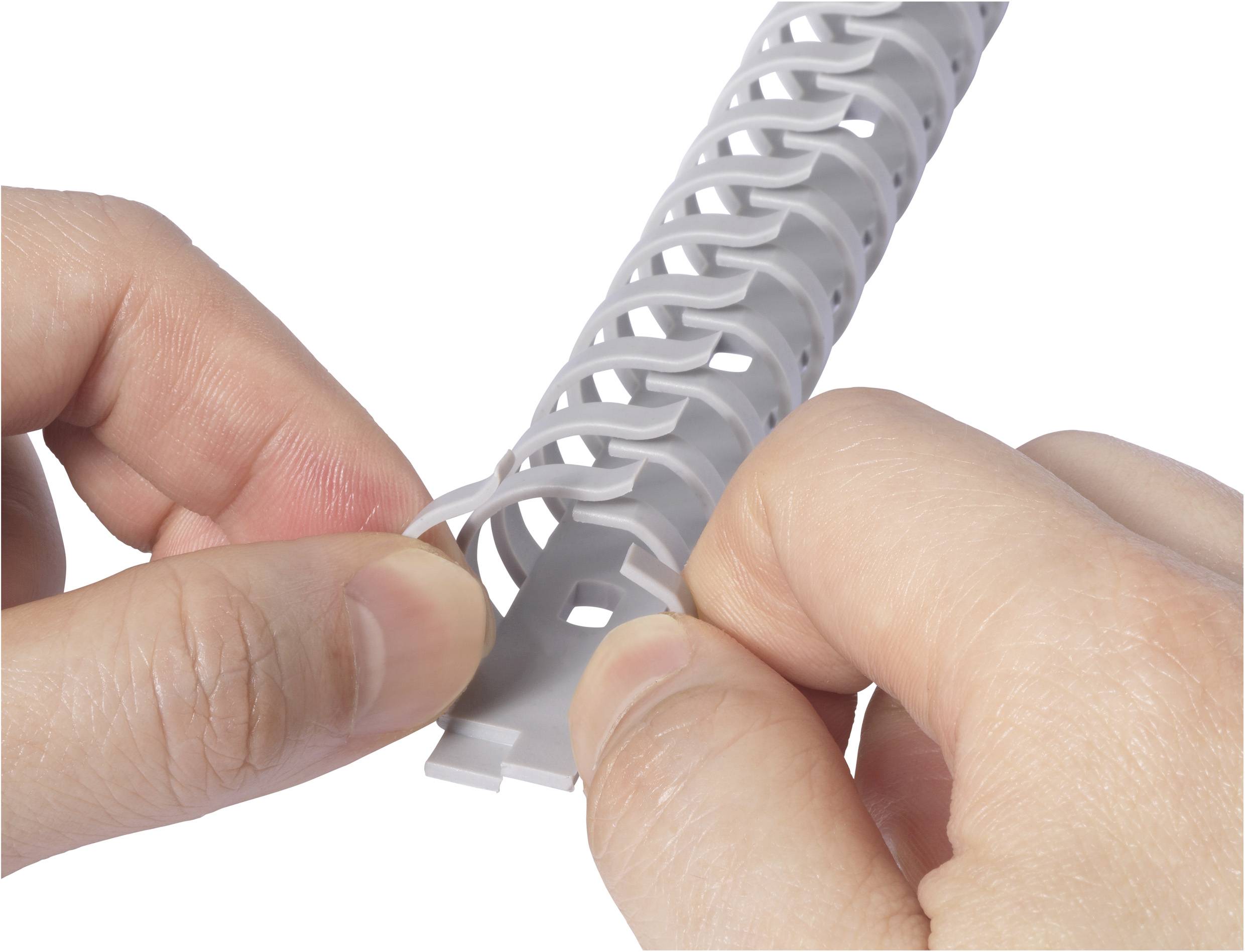 Egy személy fehér műanyag kábelvédőcsövet húz szét, hogy rendszerezze benne a kábeleket. Közeli felvétel a kezekről és a kábelvédőcsőről.