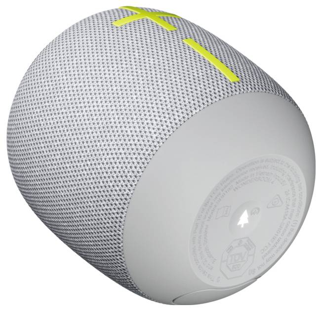 Egy hordozható, hengeres Bluetooth-hangszóró szürke szövet borítással és sárga hangerő-gombokkal a tetején.