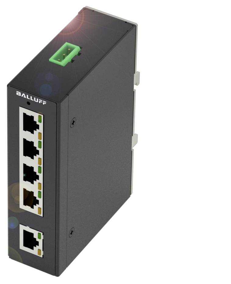 Egy fekete Ethernet-switch látható öt Ethernet-porttal és egy zöld csatlakozóval, valószínűleg Balluff márkájú.