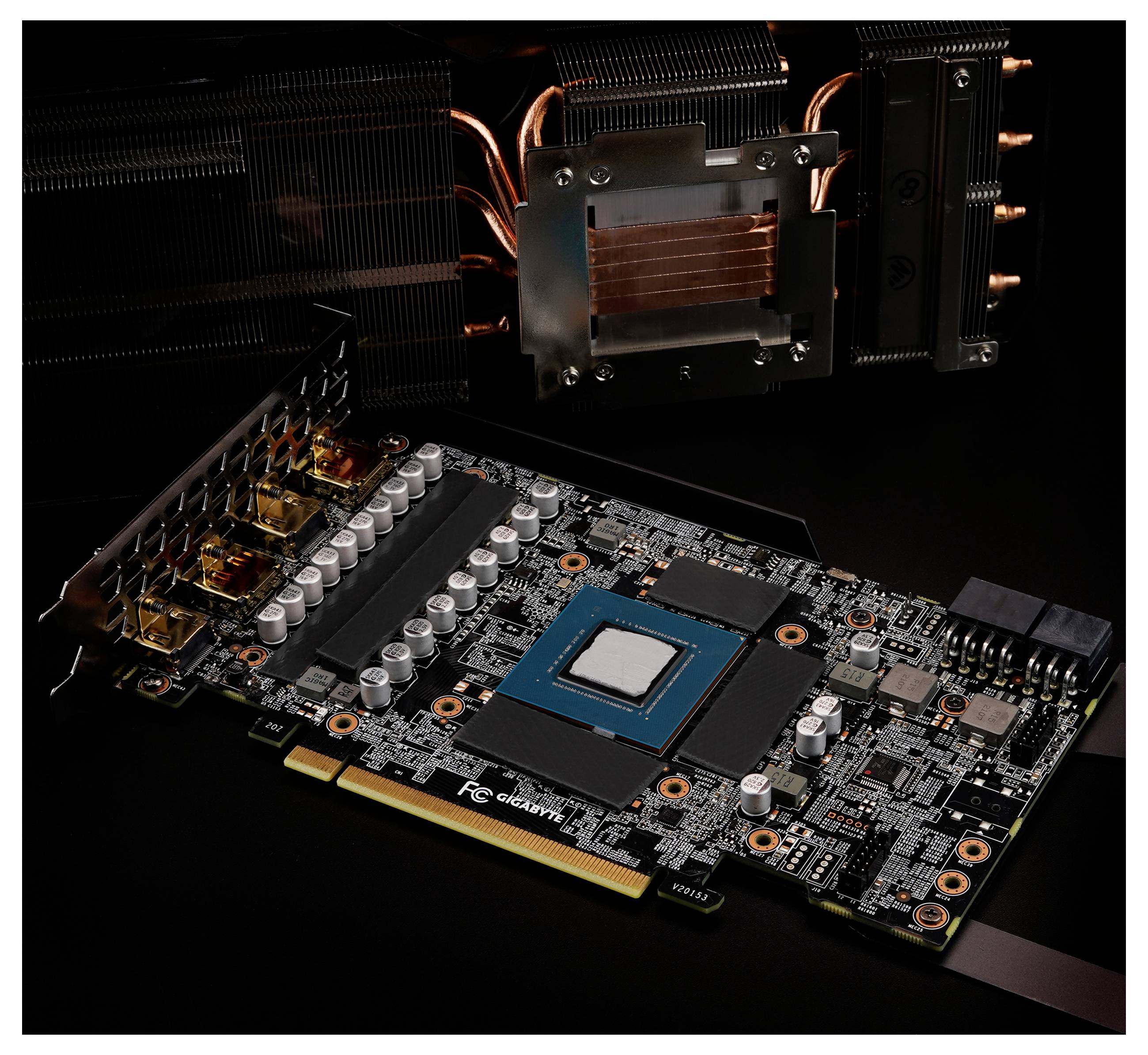 Egy számítógépes grafikai kártya látható, amelynek áramkörei és alkatrészei jól kivehetőek, a háttérben egy hűtőrendszer egy részletével.