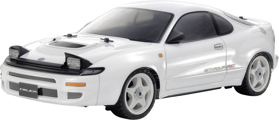 Egy fehér modellautó egy sportkocsiról, áramvonalas formatervezéssel és felnyíló fényszórókkal, amelynek az első rendszámtábla területén a 'Celica' felirat szerepel.