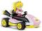 Egy játék gokart egy rózsaszín ruhás és koronás karakterrel, sárga kerekekkel és fekete részletekkel, mozgásban tűnik fel.