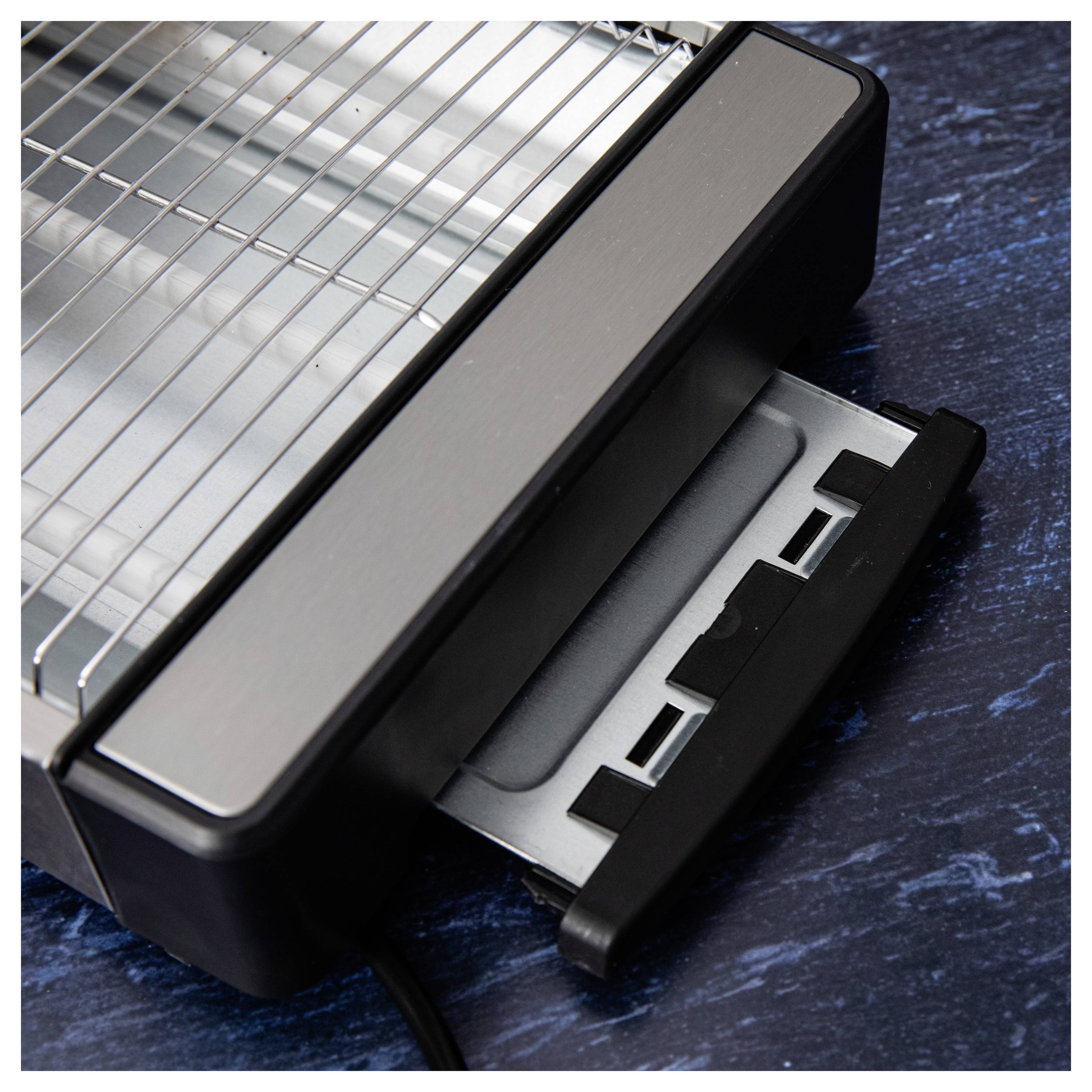 Egy elektromos grill közeli képe sötét felületen, amelyen látható egy levehető zsírfelfogó tálca, növelve a kényelmességet és a könnyű tisztíthatóságot.