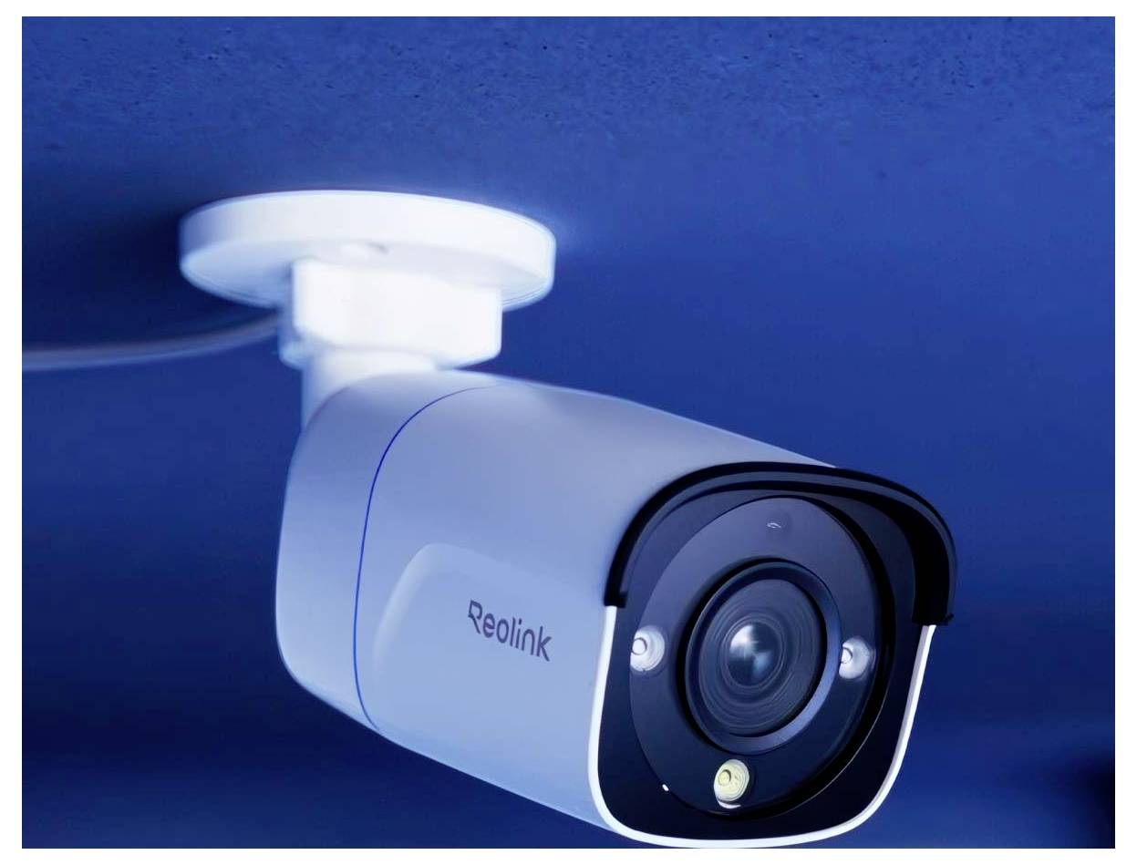 Egy fehér biztonsági kamera, amely egy kék mennyezetre van felszerelve, lefelé irányítva, amelynek az oldalán a 'Reolink' márkanév látható.