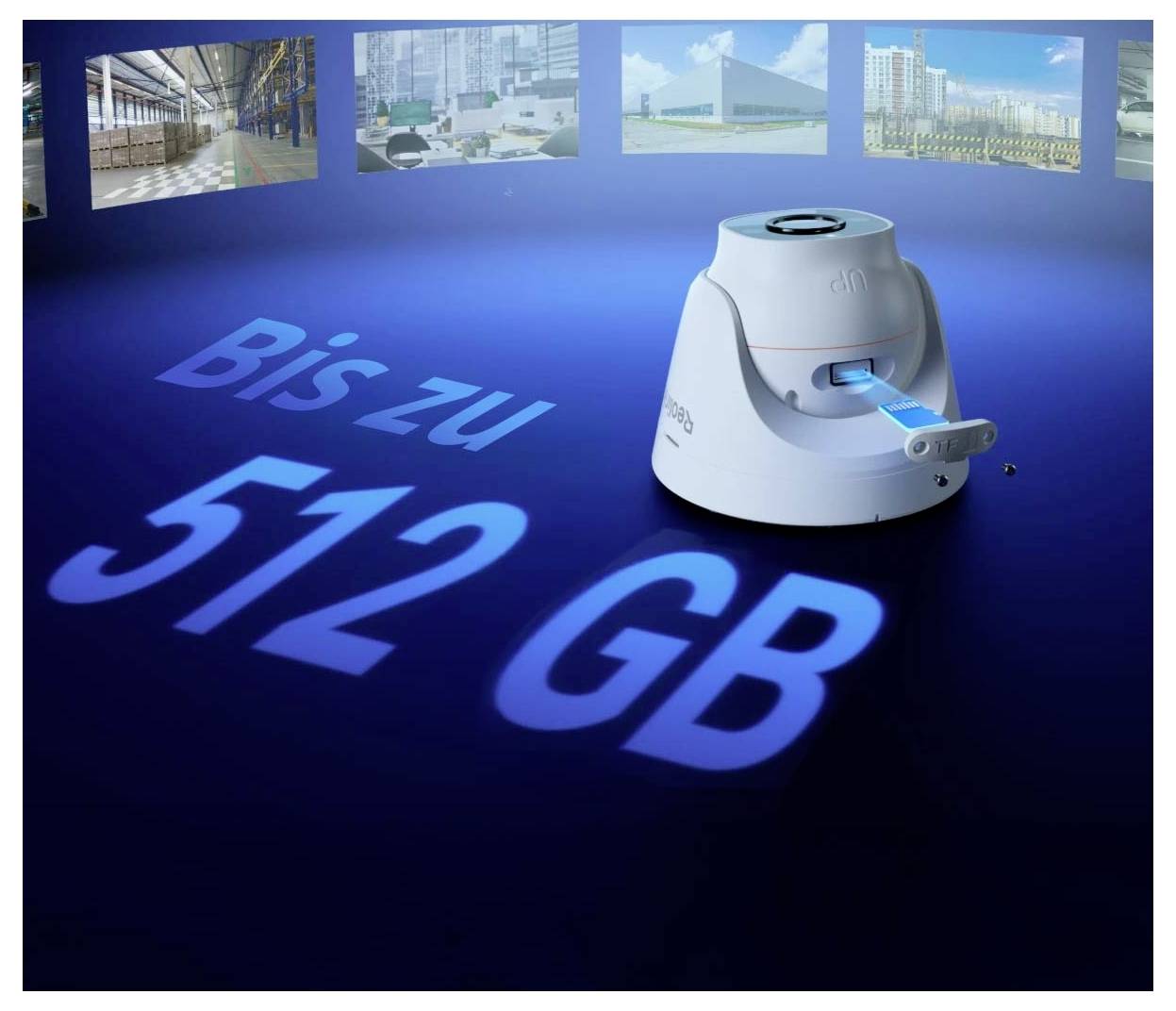 Egy kis fehér eszköz, amelyen a '512 GB-ig' felirat olvasható. A háttérben homályos képek láthatók raktárakról és épületekről.