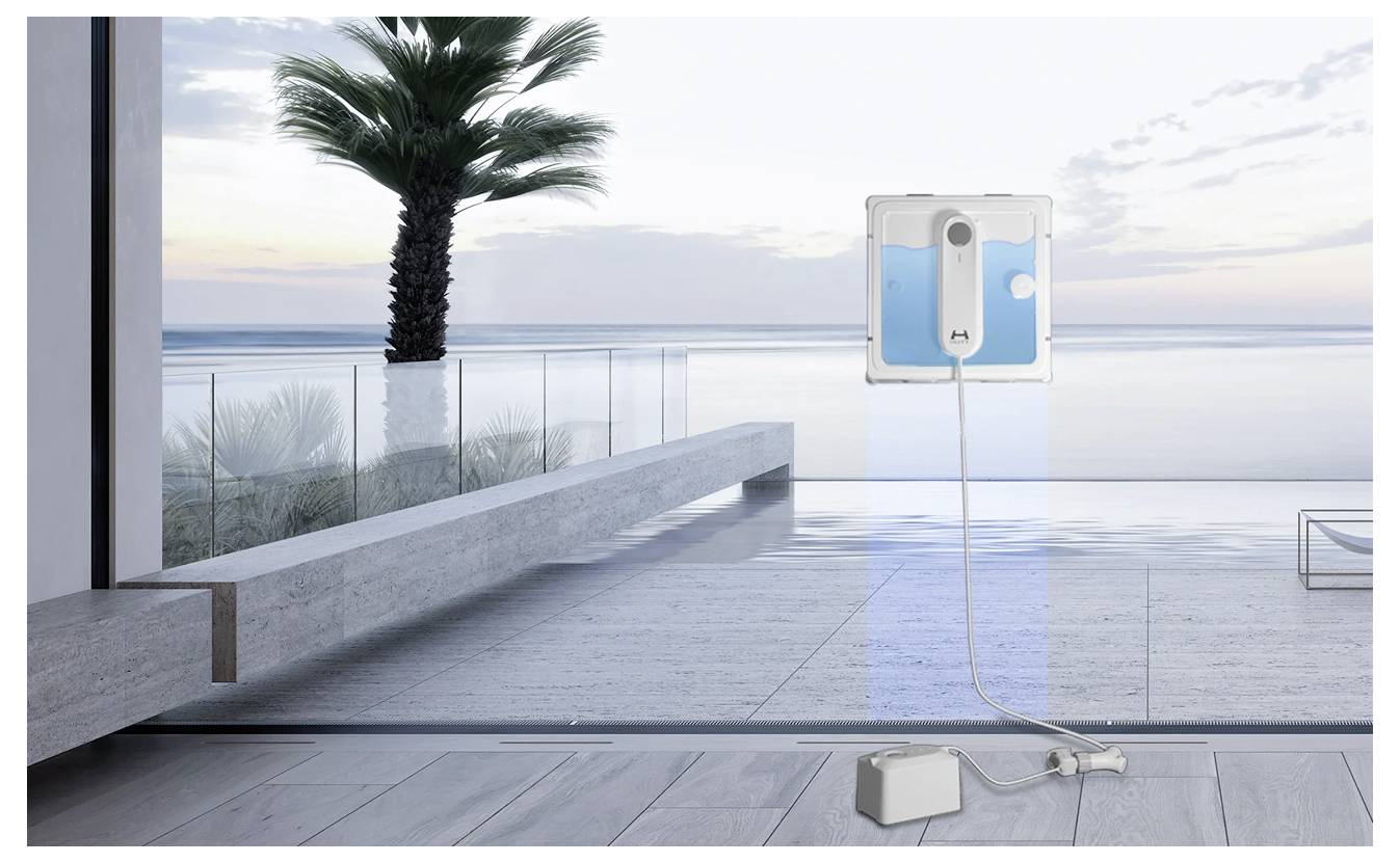 Egy robotics ablaktisztító egy nagy üvegtáblán dolgozik, melynek hátterében az óceán kilátása látható, amely az otthoni automatizált tisztítástechnológiát mutatja be.