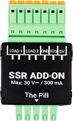 "SSR ADD-ON Max: 30 Vw / 300 mA The Pill" felirat látható egy kompakt elektromos alkatrészen, amelynek csatlakozói "LOAD 1", "LOAD 2", "GND" és "5V" címkével vannak ellátva.