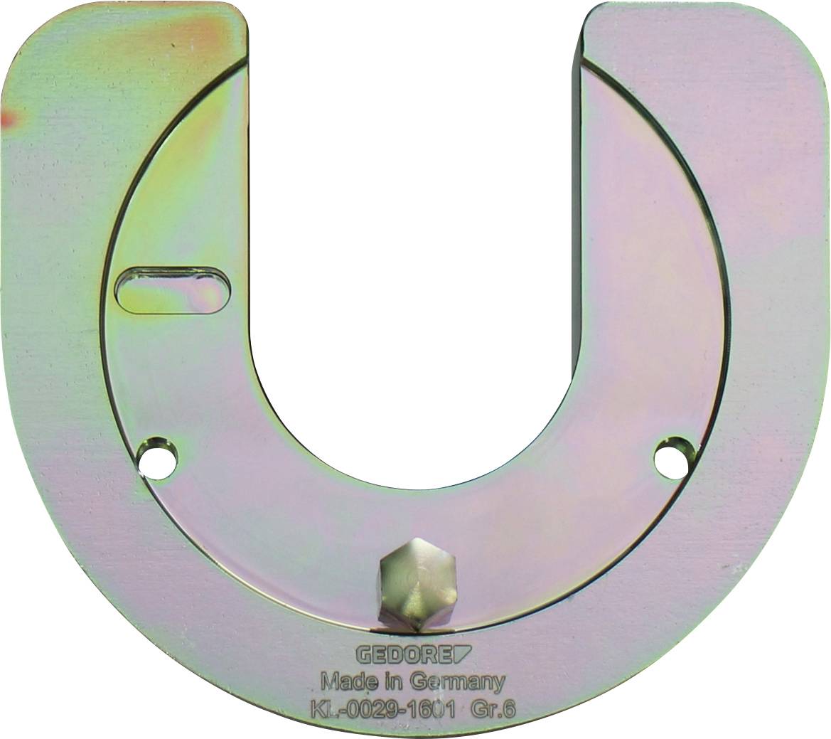 Egy U alakú, fém GEDORE szerszám, amelynek a középső alján egy kis foglalata van, „Made in Germany K1-0029-1601 Gr.S" felirattal.