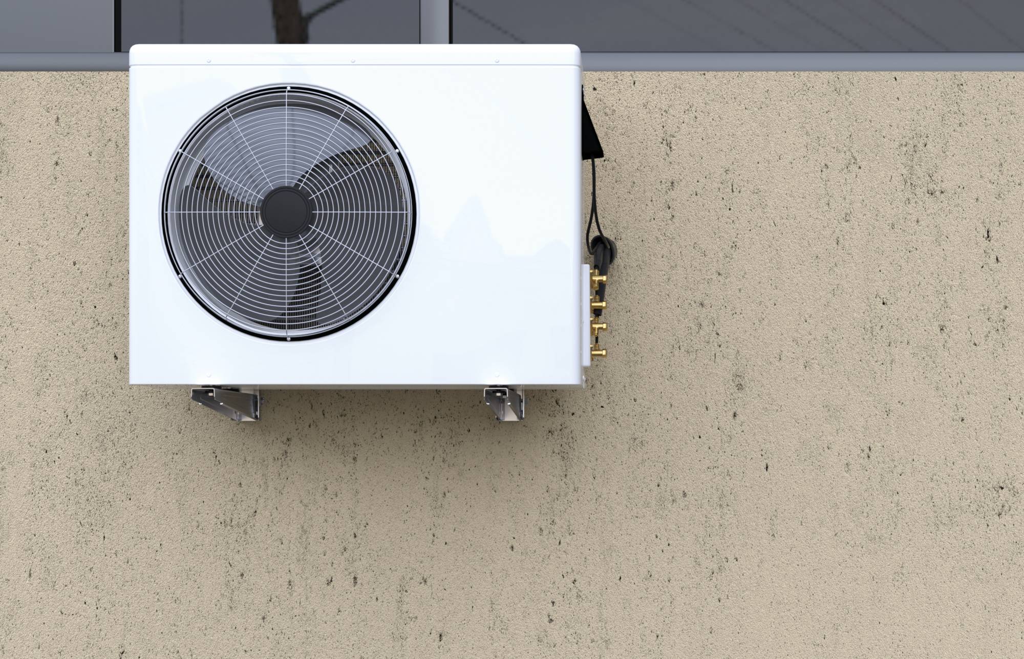 Kültéri falra szerelt légkondicionáló egység nagy kör alakú ventilátorral egy bézs színű külső falon.