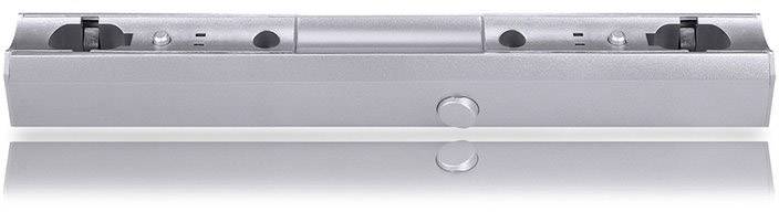 Ezüstszínű védelmi retesz, amelynek közepén hengeres gomb, két vágat a végein; fényvisszaverő felület alul.